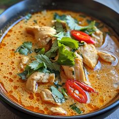 a bowl filled with chicken and vegetables on top of a table