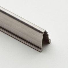 a metal tube on a white surface