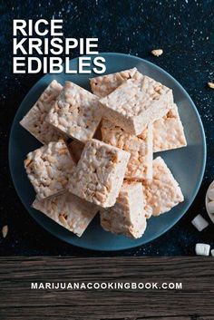 rice krispie edibles on a blue plate with marshmallows next to it