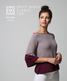 a woman in white pants and a purple sweater is posing with her arms on her hips