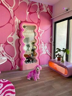 a pink dog sits in the middle of a room with an unusual wallpaper design