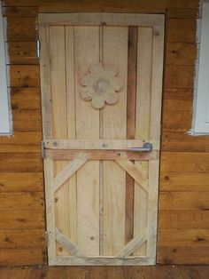 an open wooden door with a flower on it