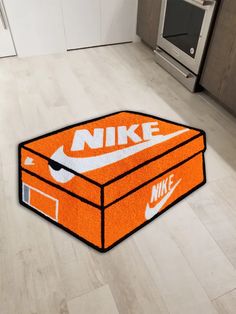 an orange nike box rug on the floor in a kitchen