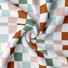 an abstract checkerboard pattern with orange, green and white squares on the fabric