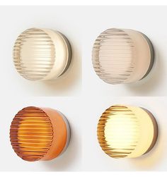 four different types of round lights on a white wall, one orange and one yellow