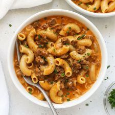 two bowls filled with pasta and meat soup