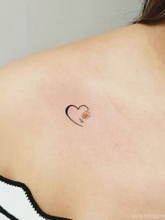 a woman with a small heart tattoo on her back