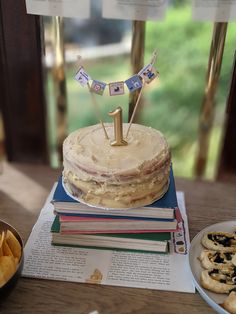 a birthday cake sitting on top of a table next to some cookies and crackers