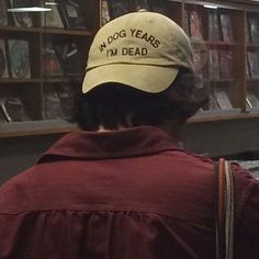 a person wearing a hat that says, my dog years i'm dead on it