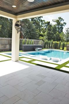 an outdoor living area with a pool and patio furniture