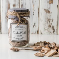 a jar filled with wood chips next to a spoon