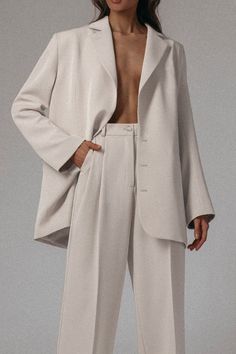 She’s an icon, she’s a legend and she IS the moment. The Icon Tailored Set takes a modern twist on a classic silhouette by featuring an oversized/relaxed fit to give it that edgy, street style flare. Add this to your cart if you’re ready to officially enter your Hailey Bieber era. COLOR: CREAM DETAILS Sold as a set TOP: Single-breasted blazer, relaxed/oversized fit, front button closure, lightly padded shoulders and back belt tightening BOTTOM: Relaxed fit, front zipper and button fastening, twi Edgy Street Style, She Is The Moment, Breasted Blazer, Edgy Look, Hailey Bieber, Care Label, Classic Silhouette, Icon Set, Single Breasted