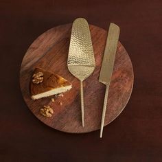 a piece of pie on a wooden plate with a knife and fork next to it