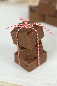 chocolate fudges stacked on top of each other with red and white twine