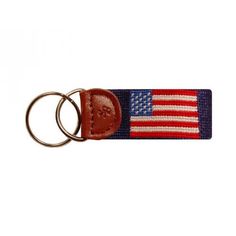 a keychain with an american flag on it and two metal rings attached to it