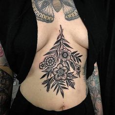 a woman with tattoos on her stomach has a butterfly and flowers tattoo on her chest