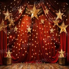 an empty stage with red curtains and gold stars