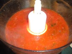 a blender filled with red liquid on top of a counter