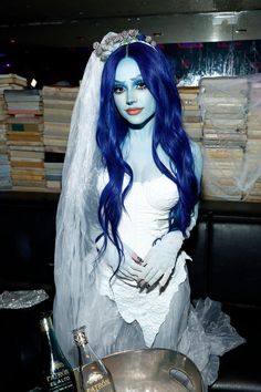 a woman dressed as corpse bride with blue hair and makeup