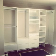 an empty white closet with shelves and drawers