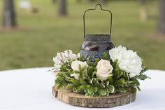 a table with a candle and flowers on it