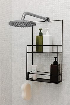 a shower head with soap and lotion on it