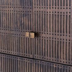 a close up of a wooden door with holes in it