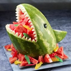 a watermelon shaped like a shark with its mouth open