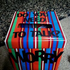 a colorful box that says do you need to talk to work? on the floor