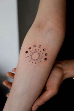 a woman's arm with dots on it and a circle in the middle,