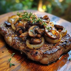 a piece of steak with mushrooms and herbs on it