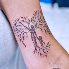 a person with a tree tattoo on their arm