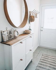 a bathroom with a sink, mirror and hanging utensils