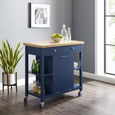 a kitchen island with a cutting board on the top and two wine bottles on it