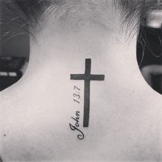 a woman's back neck with a cross and the words jesus christ on it