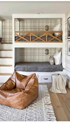 a living room with bunk beds and leather bean bag chairs in it's corner