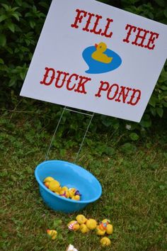 a sign that says fill the duck pond next to a blue bowl filled with rubber ducks