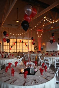 the tables are set up with red and black balloons