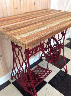 an old sewing machine table on a checkered floor