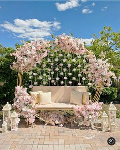 an outdoor seating area with pink flowers on it