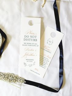 the wedding stationery is laid out on the bed