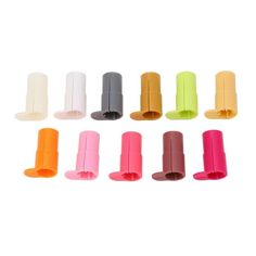 an assortment of different colored plastic objects on a white background