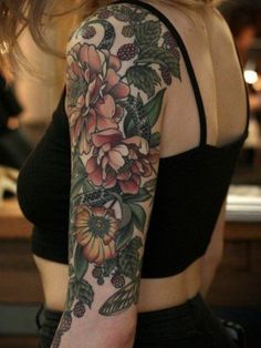 a woman with a flower tattoo on her arm