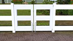 two white gates are open in front of some flowers