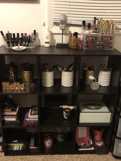 a shelf filled with lots of different types of cosmetics and other items on top of it