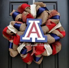 a wreath that has the letter a on it and is decorated with burlocks