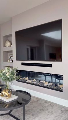 a large flat screen tv mounted to the side of a wall in a living room