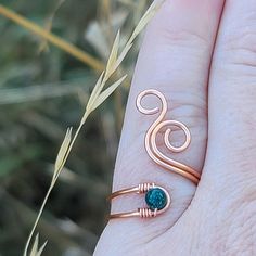 This beautiful wire wrapped ring resembles a whale spout and is made out of high quality non-tarnish coated copper wire and a beautiful green Malachite stone. Delicate and free spirited, this boho statement ring is sure to get many admiring glances!NAME: Whale SpoutSIZING: You can choose from sizes 3 to 14!STONE: Malachite: A transformation stone as it encourages risk-taking and change; A protective and powerful stone amplifying both itive and negative vibrations and grounding spiritual energies; Supports and facilitates healing by breaking down or limiting attachments and outworn patterns; Helps one to be accountable for their own actions and to “step up to the plate” with confidence when the opportunity for a leadership role presents itself; Allows us to recognize our self imed limitatio Bohemian Hand Wrapped Copper Wire Rings, Unique Green Copper Ring, Unique Green Copper Rings, Bohemian Spiral Wire Wrapped Rings, Bohemian Copper Rings, Bohemian Turquoise Wire Wrapped Rings, Ring Green Stone, Boho Statement Ring, Spiral Ring