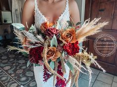 a bridal bouquet with dried flowers and feathers