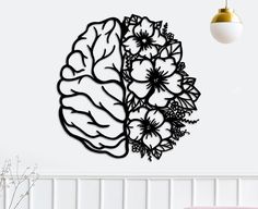 a large metal wall sculpture with flowers on it's side and the shape of a brain